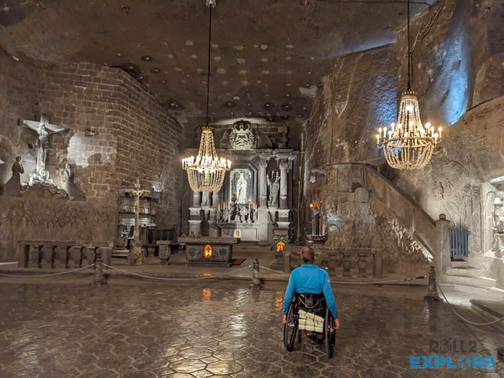 PXL_20240906_065908229.MP Nick in a wheelchair inside the Chapel of St. Kinga under salt chandeliers