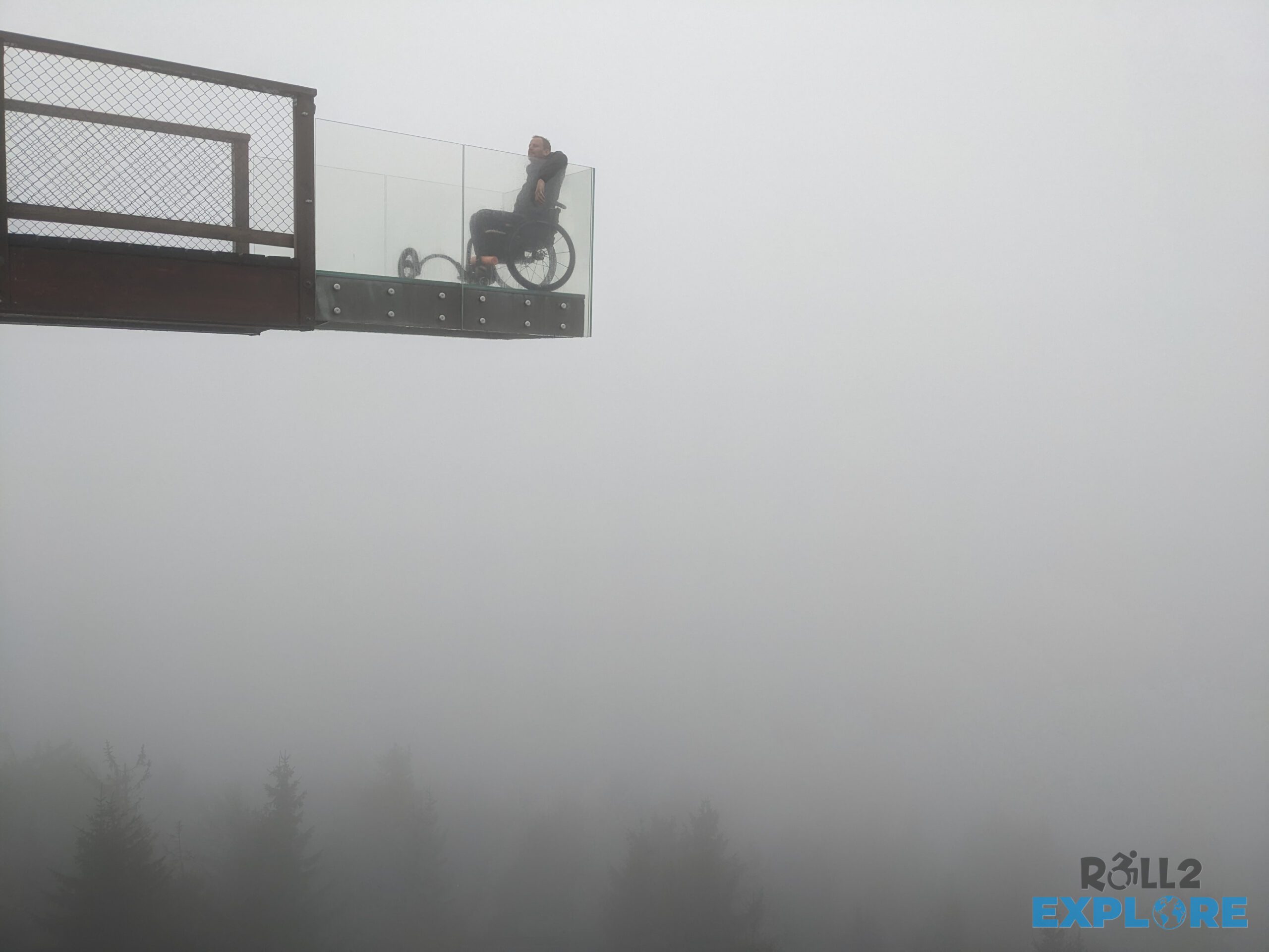 Nick in a wheelchair in the clouds on the viewpoint of Stezka Valaska