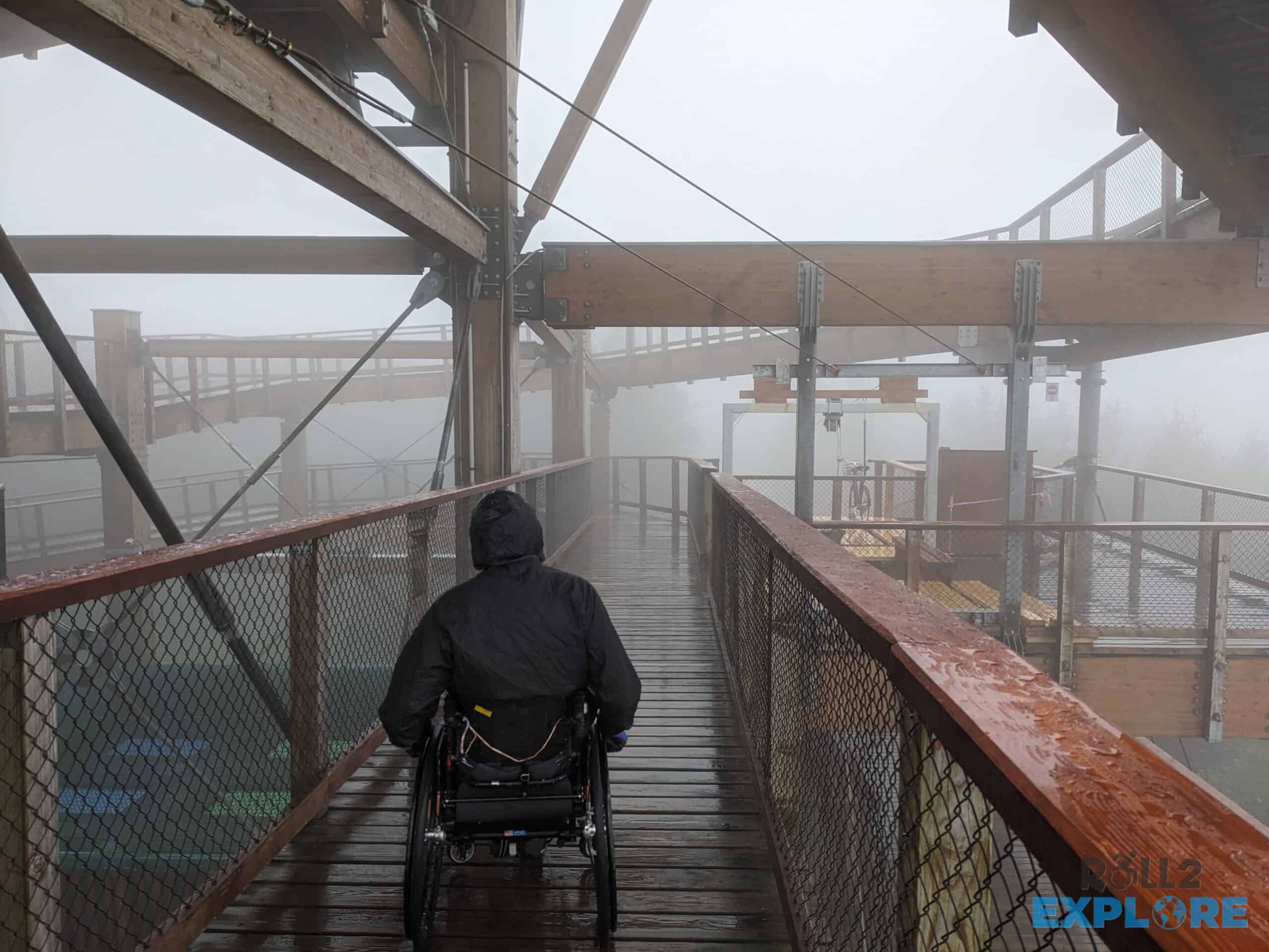 Nick in a wheelchair on the Stezka Valaska walkway in he rain